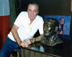 Faron Young posing with a bronze bust of Willie Nelson at the Willie Nelson museum in Nashville, Tennessee.
