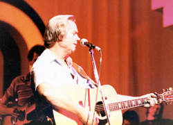George Jones playing his guitar.