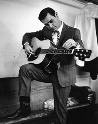 George Jones playing his guitar.